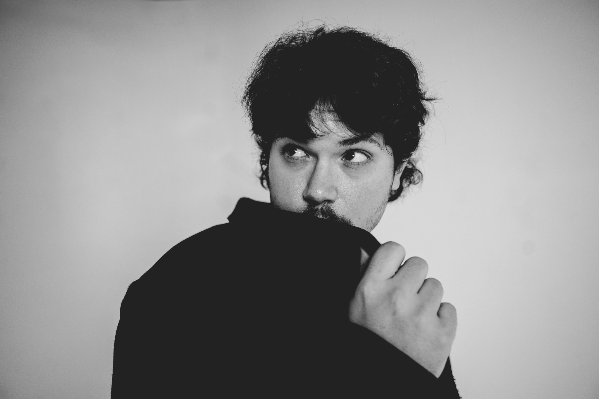 Black-and-white portrait of Tye Cristo looking to the side